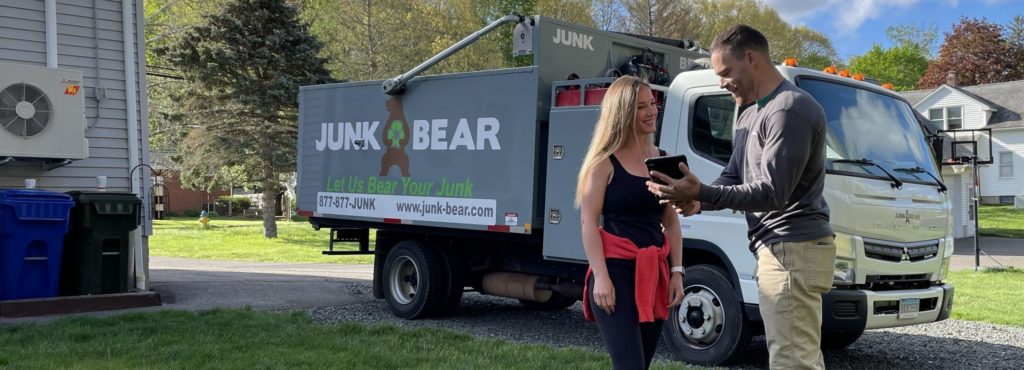 Professional for Hartford, CT junk removal interacting with a customer