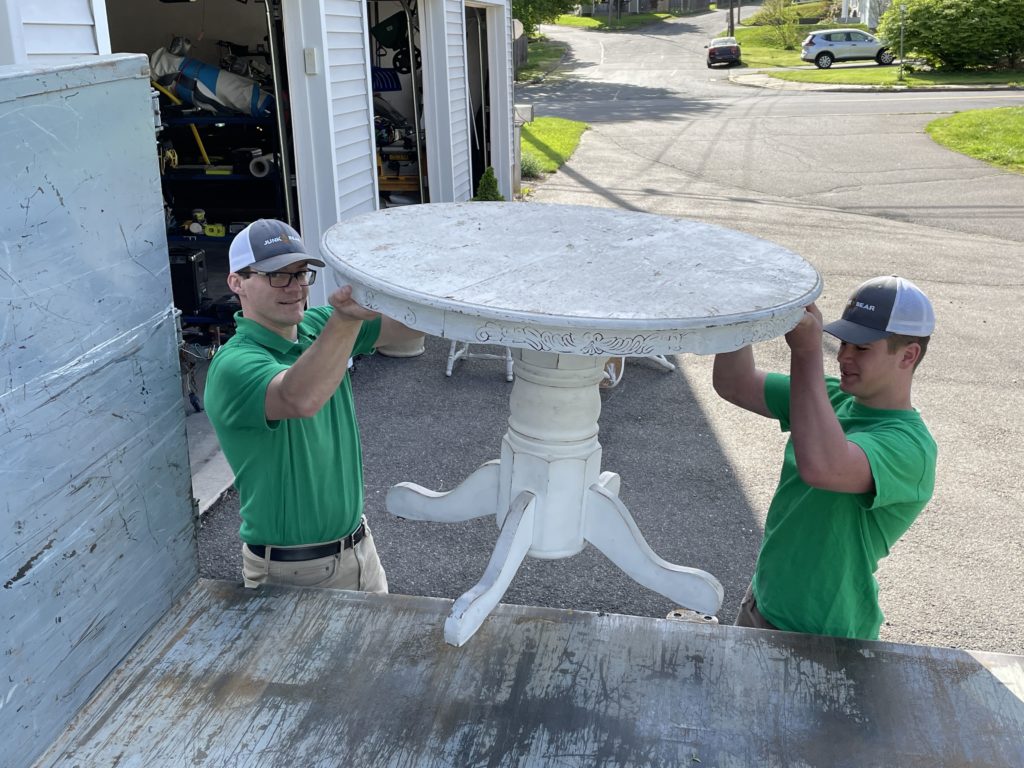 Junk Bear professionals loading a table into a truck during loading services in Connecticut
