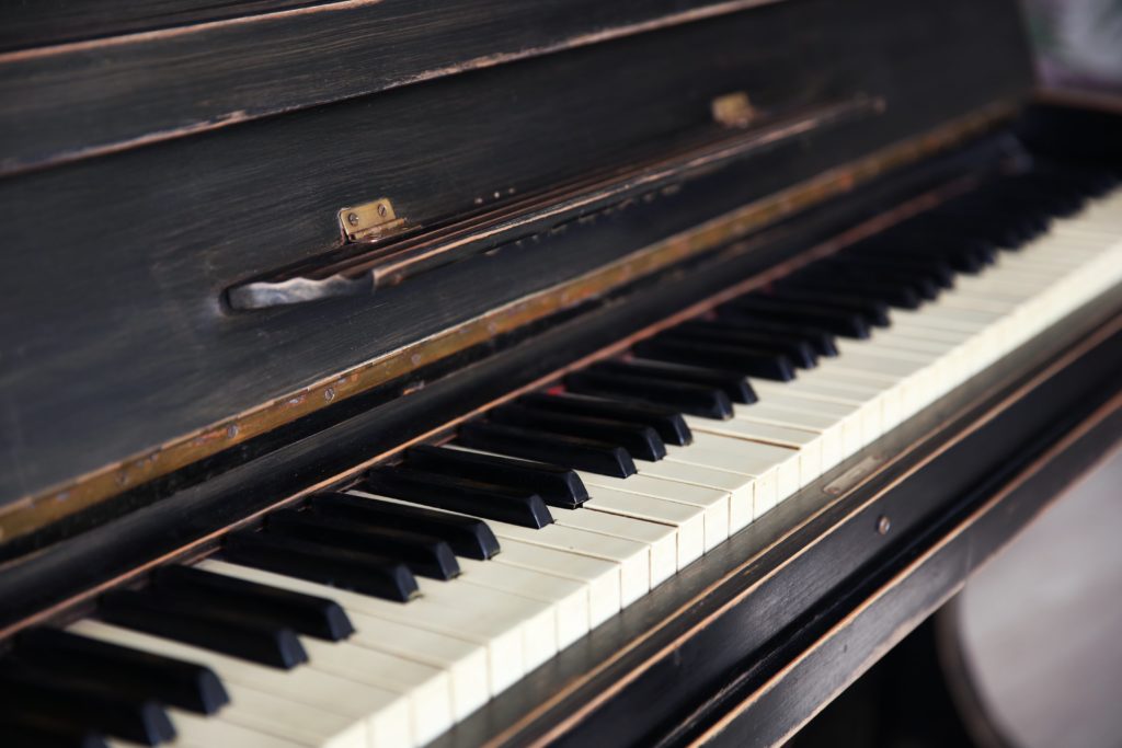 Old piano in need of piano removal services in Connecticut