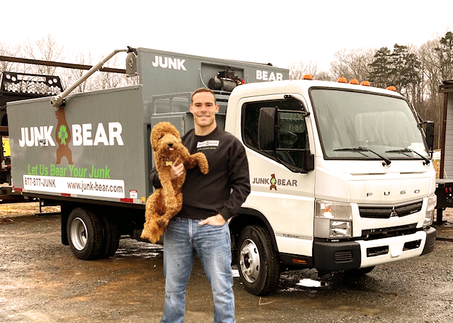 CEO of Junk Bear, Rob Paradis, holding his dog, Berkley