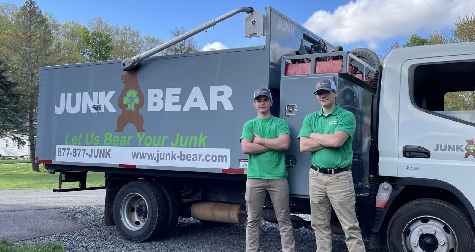 Junk Bear crew smiling next to the company truck